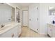 Bathroom featuring dual sinks and neutral tile flooring at 4300 Nw 4Th Cir, Ocala, FL 34475