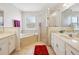 Clean bathroom featuring dual sinks, a soaking tub, and a glass enclosed shower at 4300 Nw 4Th Cir, Ocala, FL 34475