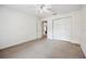 Neutral bedroom featuring neutral walls, carpet, ceiling fan, and closet at 4300 Nw 4Th Cir, Ocala, FL 34475