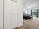 View into a large bedroom with neutral carpeting, a ceiling fan, and a large window at 4300 Nw 4Th Cir, Ocala, FL 34475