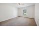 Neutral bedroom featuring neutral walls, carpet, and a window at 4300 Nw 4Th Cir, Ocala, FL 34475