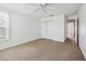 Neutral bedroom with neutral walls, carpet, closet, and window at 4300 Nw 4Th Cir, Ocala, FL 34475