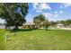 Expansive front yard showcasing lush greenery, mature trees, and well-maintained landscaping, enhancing curb appeal at 4300 Nw 4Th Cir, Ocala, FL 34475