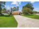 Well-manicured front lawn leading to a single-story home with a two-car garage at 4300 Nw 4Th Cir, Ocala, FL 34475