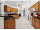 Bright kitchen with wood cabinets, black countertops, and white appliances at 4300 Nw 4Th Cir, Ocala, FL 34475