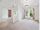 Open living space with carpeted floors, a large window, and a view into other rooms at 4300 Nw 4Th Cir, Ocala, FL 34475