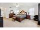 Large main bedroom featuring carpet flooring, a full set of bedroom furniture, and natural light at 4300 Nw 4Th Cir, Ocala, FL 34475