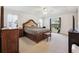 Spacious bedroom features a large bed, a window with natural light, and carpet flooring at 4300 Nw 4Th Cir, Ocala, FL 34475