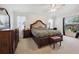Bright main bedroom features a large bed, side tables, and a ceiling fan at 4300 Nw 4Th Cir, Ocala, FL 34475