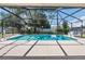 Inviting screened-in pool area with clear blue water, surrounded by ample deck space, ideal for relaxation and outdoor enjoyment at 4300 Nw 4Th Cir, Ocala, FL 34475