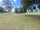 Expansive backyard featuring a white fence and a garden bed, perfect for outdoor enjoyment at 5917 Ne 61St Avenue Rd, Silver Springs, FL 34488