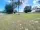 Beautiful backyard with a white fence and mature trees, offering a peaceful outdoor retreat at 5917 Ne 61St Avenue Rd, Silver Springs, FL 34488