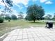 Spacious backyard with a grill, paver patio, and a white fence, offering ample outdoor space at 5917 Ne 61St Avenue Rd, Silver Springs, FL 34488