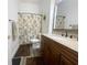 Updated bathroom featuring a wood vanity, a granite countertop, and a shower with tub combination at 5917 Ne 61St Avenue Rd, Silver Springs, FL 34488