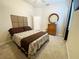 Bedroom with a cozy bed, dresser and round mirror is perfect for relaxing at the end of the day at 5917 Ne 61St Avenue Rd, Silver Springs, FL 34488