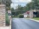 Gated community entrance featuring secure access, brick columns, and professional landscaping at 5917 Ne 61St Avenue Rd, Silver Springs, FL 34488