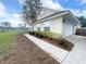 Well-maintained home with a two-car garage, a sidewalk, and professional landscaping at 5917 Ne 61St Avenue Rd, Silver Springs, FL 34488