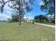 Charming single-Gathering home with a large front yard, mature trees, and an inviting entryway at 5917 Ne 61St Avenue Rd, Silver Springs, FL 34488