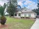 Inviting single-Gathering home with a welcoming front porch, lush lawn, and mature trees at 5917 Ne 61St Avenue Rd, Silver Springs, FL 34488