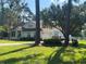 Well-kept home featuring a two-car garage, a charming front porch, and mature landscaping at 5917 Ne 61St Avenue Rd, Silver Springs, FL 34488