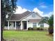 Charming single-Gathering home with a cozy front porch, well-manicured lawn and a beautiful palm tree at 5917 Ne 61St Avenue Rd, Silver Springs, FL 34488