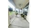 Inviting covered front porch featuring a ceiling fan, swing, and ample space for potted plants at 5917 Ne 61St Avenue Rd, Silver Springs, FL 34488