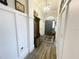 Entryway hallway with a hall tree, a chandelier, and a dark front door is very inviting at 5917 Ne 61St Avenue Rd, Silver Springs, FL 34488