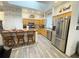 Bright kitchen with skylight, wood cabinets, stone accent wall and eat-in kitchen island at 5917 Ne 61St Avenue Rd, Silver Springs, FL 34488