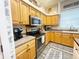 Well-lit kitchen with stainless appliances and stone countertops at 5917 Ne 61St Avenue Rd, Silver Springs, FL 34488