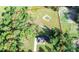 Expansive property featuring a modern home, green fields, mature trees, a small pond, and fenced perimeter at 7 Hill Prince Dr, Ocala, FL 34482