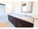Bathroom showcasing a double vanity with granite countertops and framed mirrors at 7 Hill Prince Dr, Ocala, FL 34482