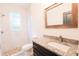 Bathroom featuring a granite countertop, wood-framed mirror, and a walk-in shower with decorative tile at 7 Hill Prince Dr, Ocala, FL 34482