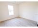 Cozy bedroom with light-colored floors, a window that allows natural light into the room, and base molding at 7 Hill Prince Dr, Ocala, FL 34482