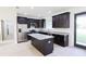 Modern kitchen featuring dark wood cabinets, granite countertops, stainless steel appliances, and center island at 7 Hill Prince Dr, Ocala, FL 34482