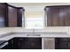 Close-up of modern kitchen cabinets with granite countertops and stainless steel appliances at 7 Hill Prince Dr, Ocala, FL 34482