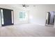 Bright living room with light wood-look floors, large window, and a dark front door with sidelights at 7 Hill Prince Dr, Ocala, FL 34482