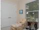 Bedroom with a plush chair, sewing table, window, and white doors with silver hardware at 7695 Sw 188Th Ave, Dunnellon, FL 34432