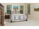 Bedroom with a wrought iron bed frame and neutral decor at 7695 Sw 188Th Ave, Dunnellon, FL 34432