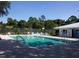Community pool with chairs and tables, offering a perfect spot for relaxation and recreation at 7695 Sw 188Th Ave, Dunnellon, FL 34432