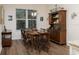 Cozy dining room with a large window, a stylish chandelier, and an antique china cabinet at 7695 Sw 188Th Ave, Dunnellon, FL 34432