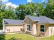 Close-up of home's exterior showing tasteful landscaping and a glimpse of the backyard at 7695 Sw 188Th Ave, Dunnellon, FL 34432