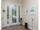 Elegant foyer featuring a decorative glass door, wood floors, and stylish decor at 7695 Sw 188Th Ave, Dunnellon, FL 34432