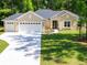 Charming single-story home with a three-car garage and a well-manicured front lawn at 7695 Sw 188Th Ave, Dunnellon, FL 34432