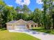 Inviting single-Gathering home with a three-car garage and lush green lawn at 7695 Sw 188Th Ave, Dunnellon, FL 34432