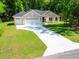Beautiful single-story home featuring a three-car garage and long driveway at 7695 Sw 188Th Ave, Dunnellon, FL 34432