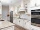 Bright kitchen featuring custom cabinets, granite countertops, and modern stainless steel appliances at 7695 Sw 188Th Ave, Dunnellon, FL 34432