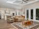 Open-concept living room featuring wood flooring, a coffered ceiling, and access to the kitchen at 7695 Sw 188Th Ave, Dunnellon, FL 34432