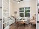 Bright living room with hardwood floors, floral sofas, a ceiling fan, and a window with natural light at 7695 Sw 188Th Ave, Dunnellon, FL 34432