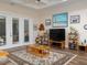 Comfortable living room featuring an area rug, a coffee table, and sliding glass doors at 7695 Sw 188Th Ave, Dunnellon, FL 34432