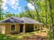 Back of the house with screened in porch with view of treed lot at 7695 Sw 188Th Ave, Dunnellon, FL 34432